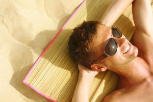 guy sleeping beach_12610921