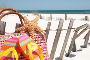 wooden dune fense with flip flops and starfish