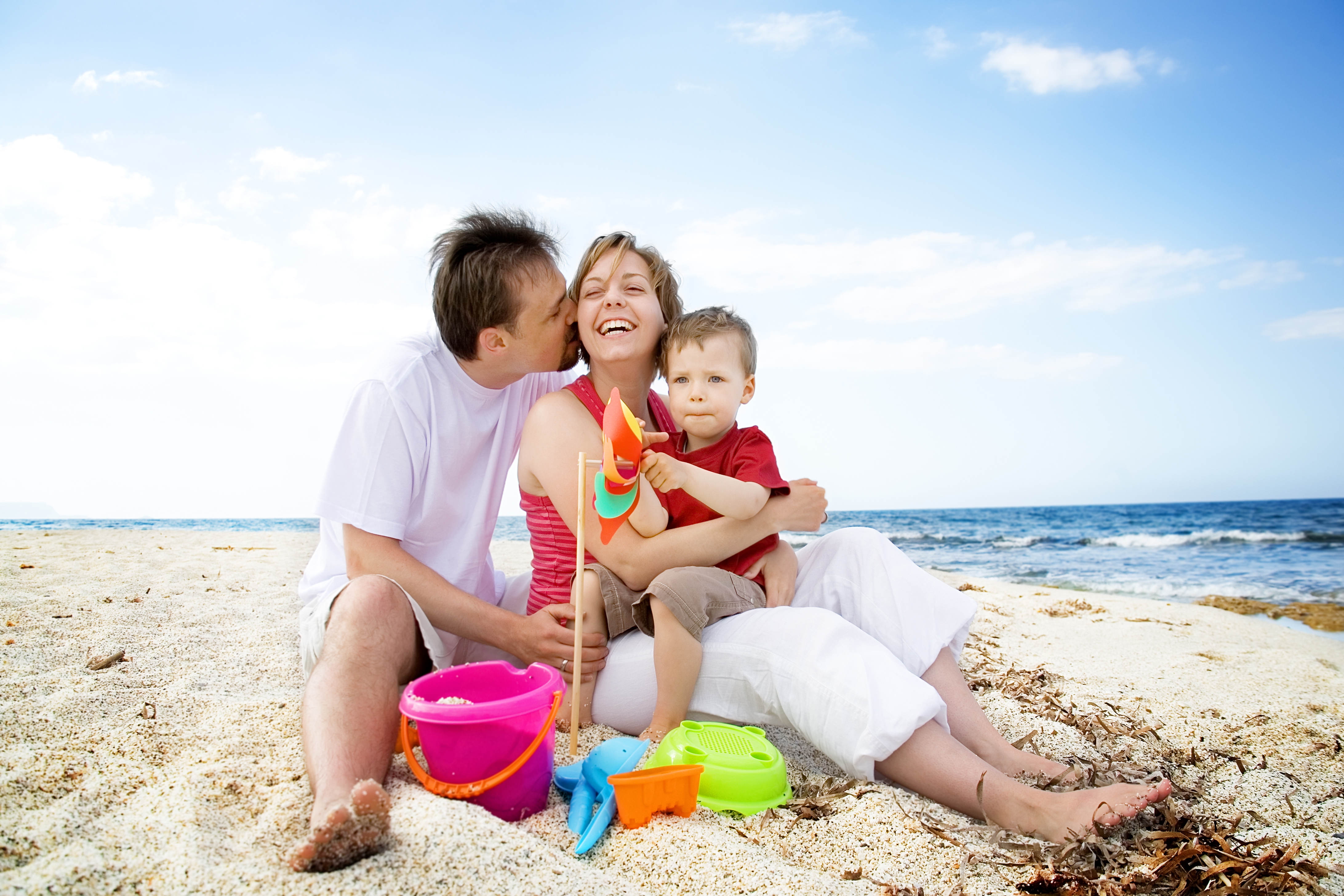 Parents and Son Laughing on the Beach